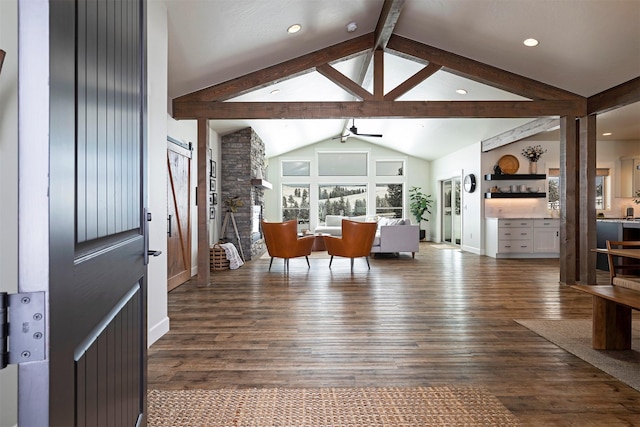 interior space with beamed ceiling, ceiling fan, dark hardwood / wood-style flooring, and high vaulted ceiling