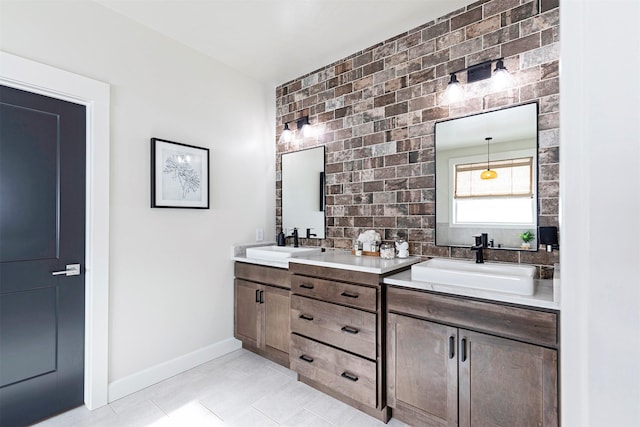 bathroom with vanity, tile patterned flooring, and brick wall