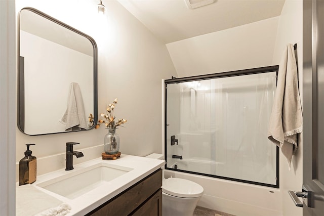 full bathroom featuring vanity, vaulted ceiling, toilet, and combined bath / shower with glass door