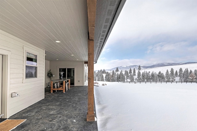 snowy yard with a mountain view