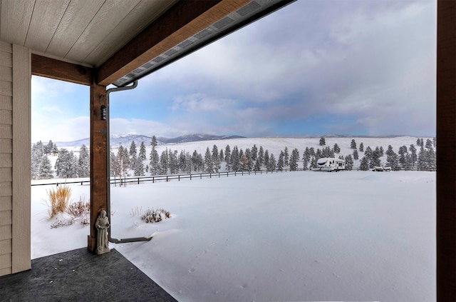 yard covered in snow with a mountain view