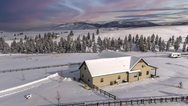 snowy aerial view with a mountain view