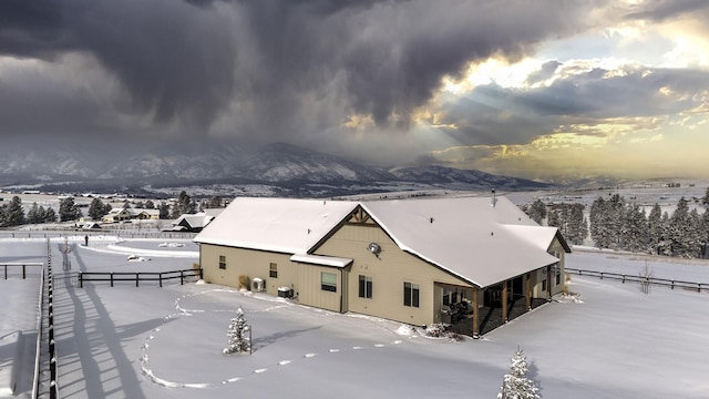 snowy aerial view featuring a mountain view