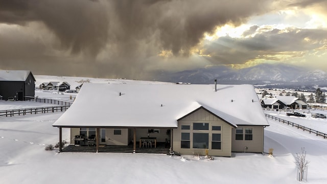 snow covered property featuring a mountain view