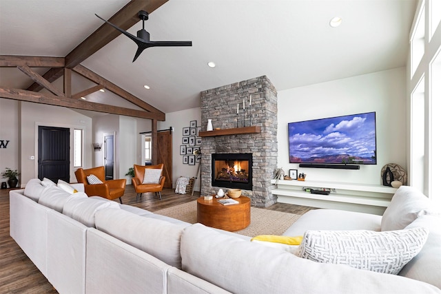 living room with a wealth of natural light, vaulted ceiling with beams, and dark wood-type flooring