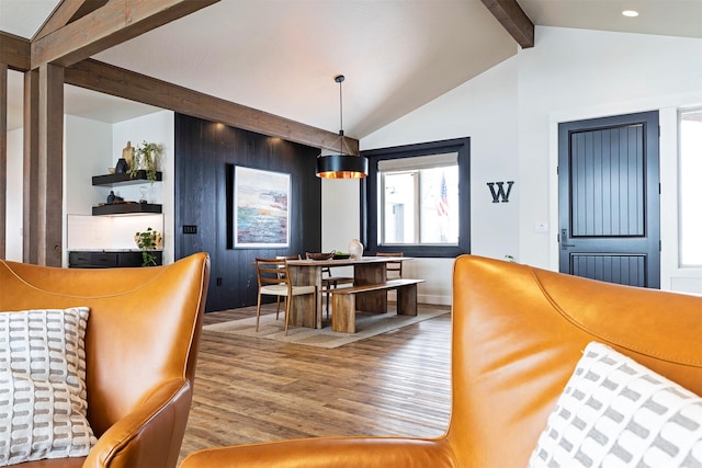 dining area with vaulted ceiling with beams and light hardwood / wood-style flooring