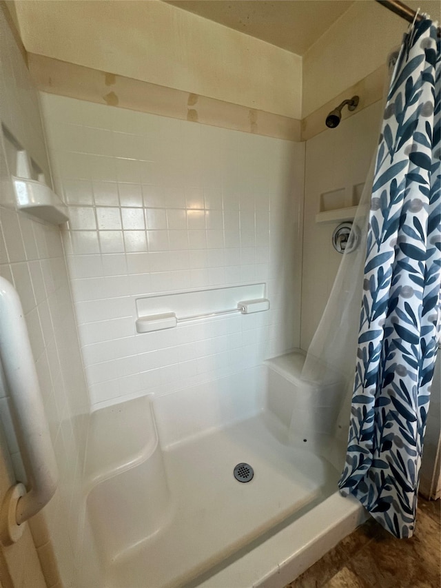 full bathroom featuring a shower stall