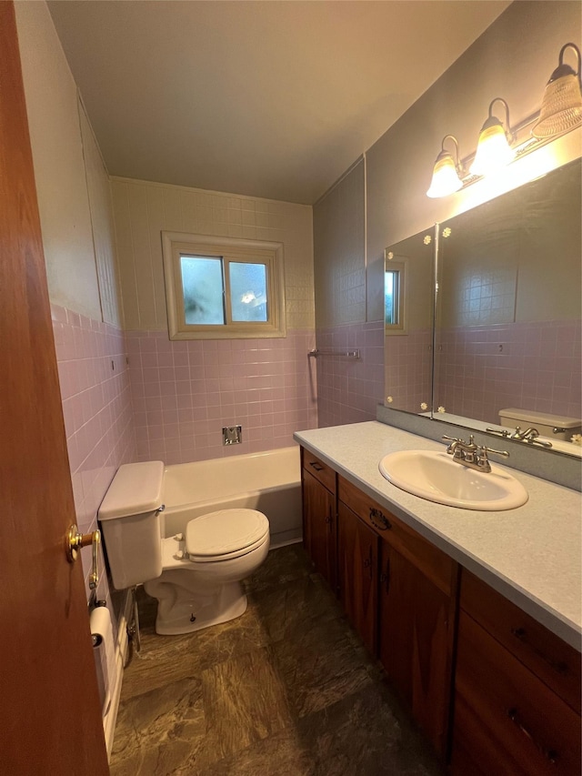 bathroom with a tub to relax in, toilet, tile walls, and vanity