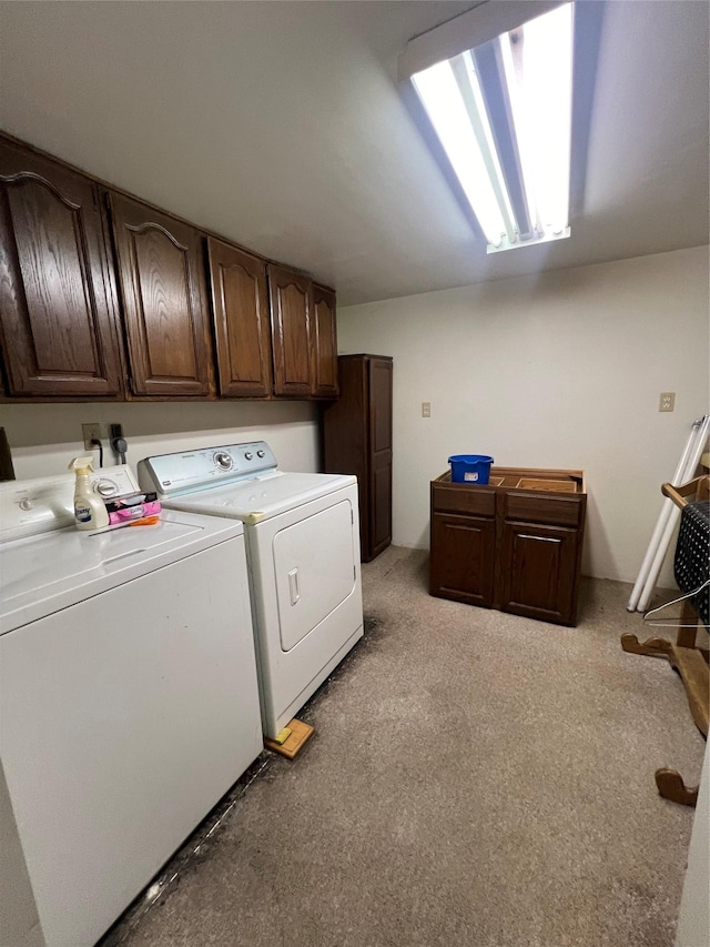 clothes washing area with cabinet space and washing machine and clothes dryer