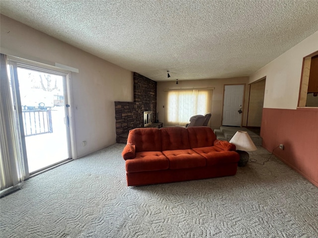 living area with a healthy amount of sunlight, light carpet, a textured ceiling, and lofted ceiling