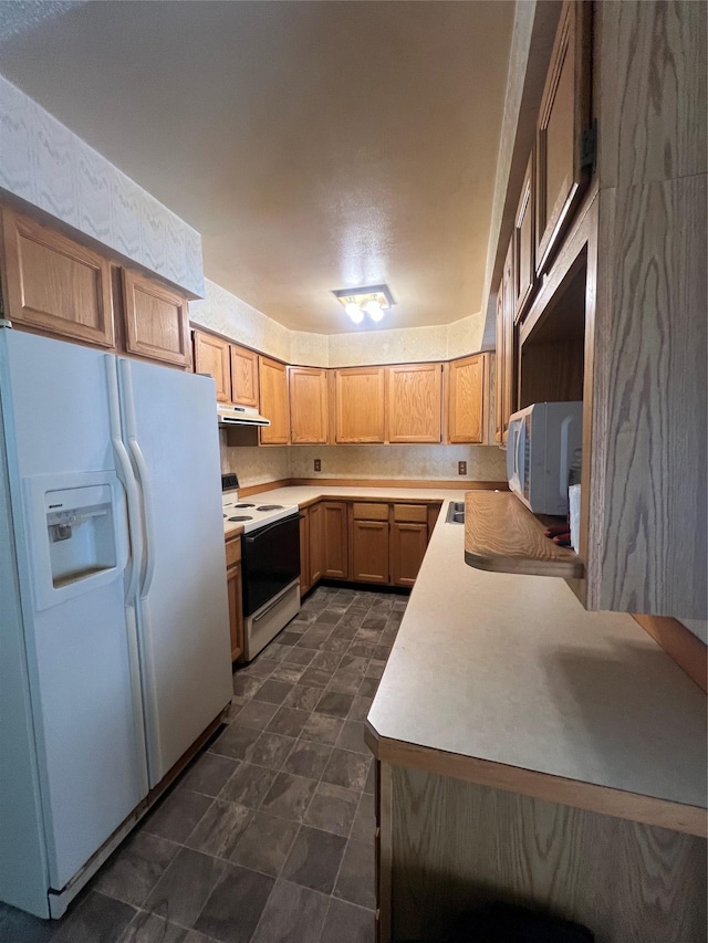 kitchen featuring light countertops, white appliances, and under cabinet range hood