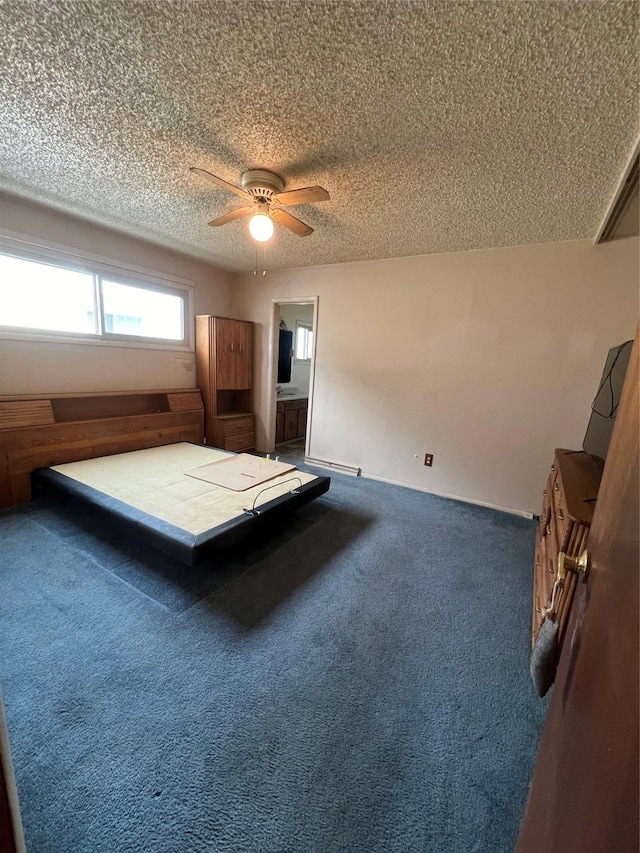 unfurnished bedroom featuring a textured ceiling, carpet floors, and a ceiling fan