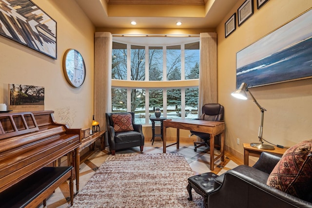 home office featuring a tray ceiling and a towering ceiling