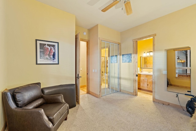 sitting room with light colored carpet and ceiling fan