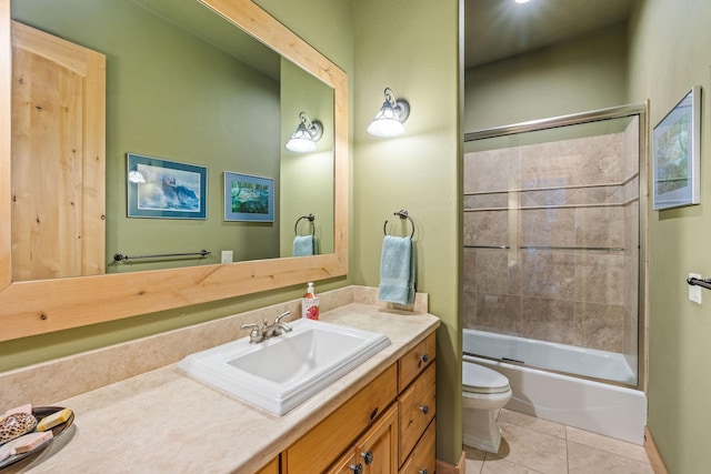 full bathroom with toilet, tile patterned floors, shower / bath combination with glass door, and vanity