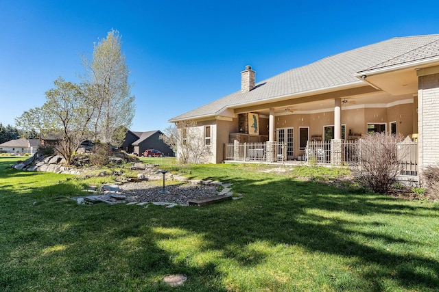 view of yard with ceiling fan