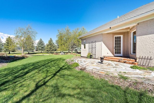 107 Whitetail Ct, Bigfork, MT 59911 - view of green lawn with a patio area