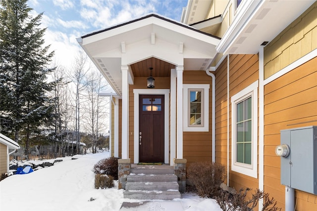 view of snow covered property entrance