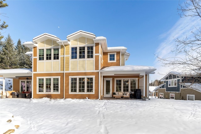 view of snow covered rear of property