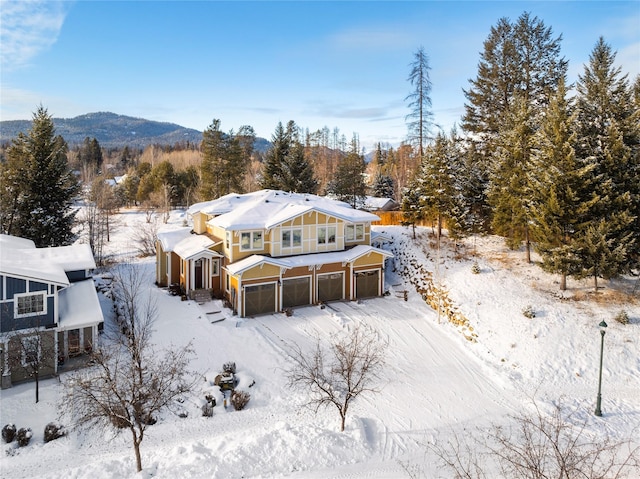 snowy aerial view with a mountain view