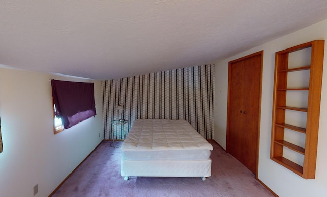 unfurnished bedroom with carpet and a textured ceiling