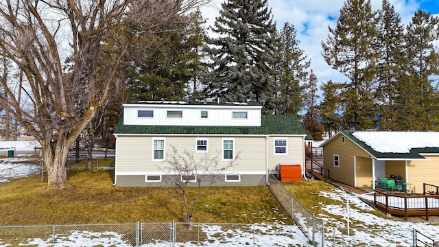 snow covered property featuring a yard