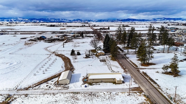 snowy aerial view featuring a mountain view