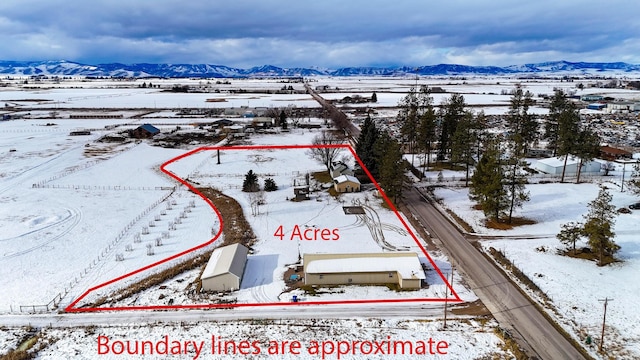 snowy aerial view with a mountain view