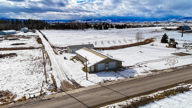 snowy aerial view featuring a mountain view