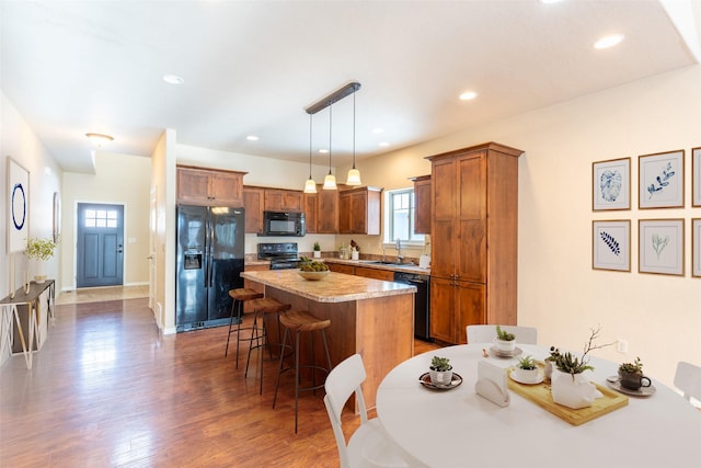 28 Talbot Pines Loop, Columbia Falls, MT 59912 - kitchen with black appliances, a kitchen breakfast bar, a kitchen island, plenty of natural light, and recessed lighting