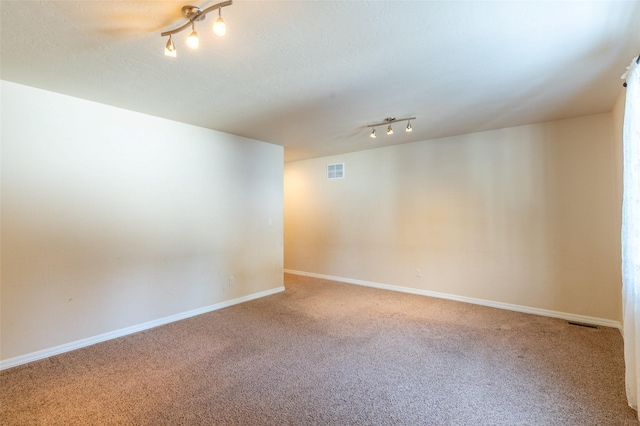 28 Talbot Pines Loop, Columbia Falls, MT 59912 - empty room with carpet flooring, track lighting, and a textured ceiling