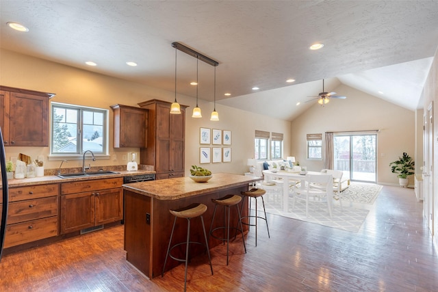 28 Talbot Pines Loop, Columbia Falls, MT 59912 - kitchen with open floor plan, a center island, brown cabinets, a kitchen breakfast bar, and dark wood-type flooring