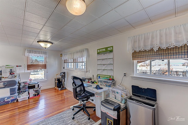 office space with wood finished floors and baseboards