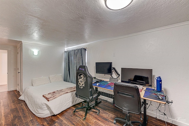 bedroom with a textured ceiling, a textured wall, wood finished floors, and crown molding