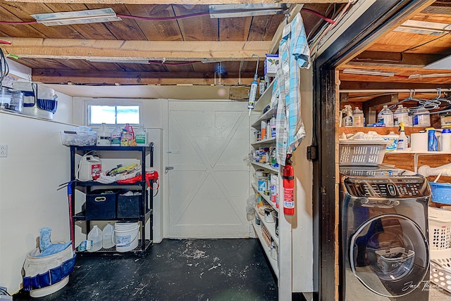 below grade area featuring washer / clothes dryer, visible vents, and wooden ceiling