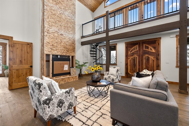 living room featuring hardwood / wood-style flooring and high vaulted ceiling