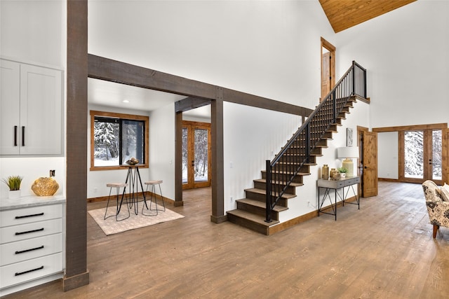 foyer with french doors, dark hardwood / wood-style floors, and a high ceiling