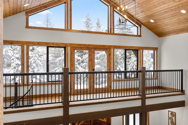 interior space with a notable chandelier, lofted ceiling, and wooden ceiling