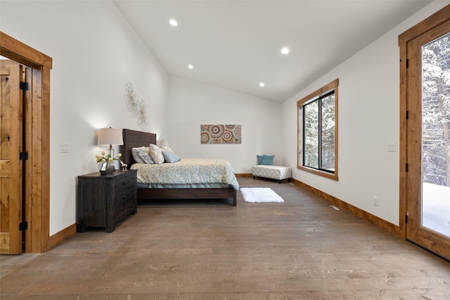 bedroom featuring lofted ceiling, hardwood / wood-style floors, and access to outside