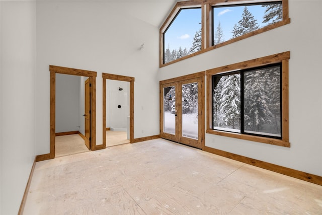 interior space featuring french doors and a towering ceiling