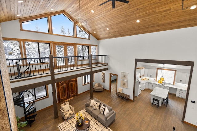 living room featuring dark hardwood / wood-style flooring, ceiling fan with notable chandelier, wooden ceiling, and high vaulted ceiling