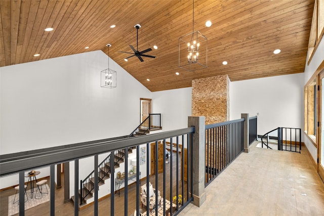 hallway with hardwood / wood-style flooring, a chandelier, high vaulted ceiling, and wooden ceiling