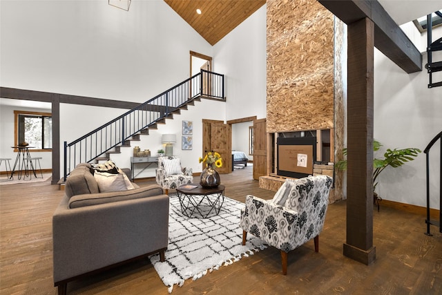 living room with dark hardwood / wood-style floors, wood ceiling, and a towering ceiling