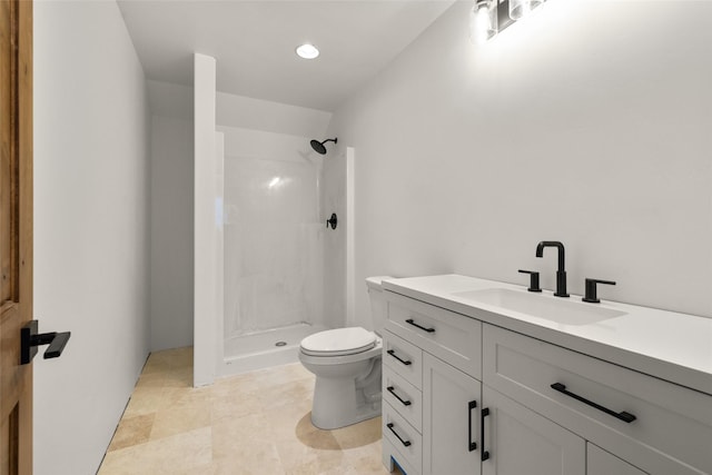 bathroom featuring vanity, a shower, and toilet