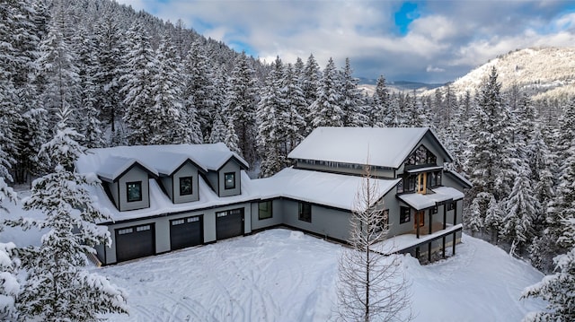 view of front facade with a mountain view and a garage