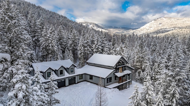 snowy aerial view featuring a mountain view