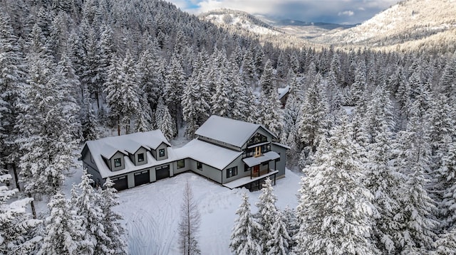 snowy aerial view with a mountain view