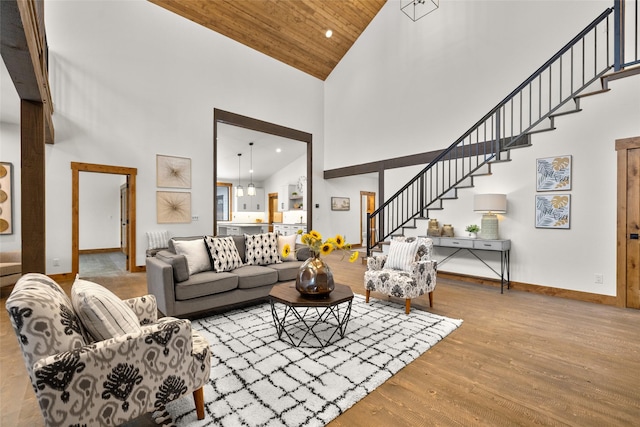 living room featuring light wood-type flooring, wood ceiling, and high vaulted ceiling