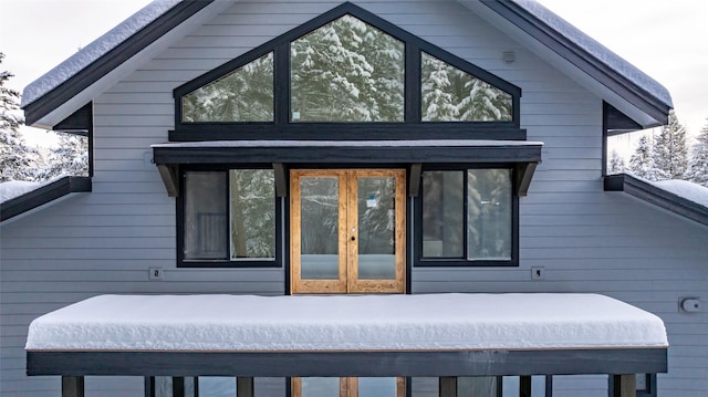 view of snow covered exterior featuring french doors