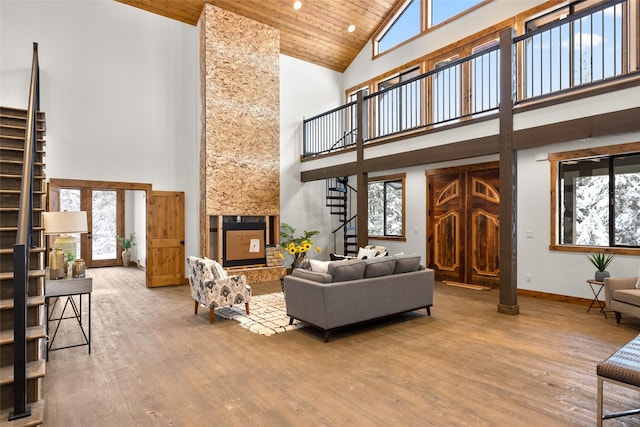 living room with hardwood / wood-style flooring, wooden ceiling, and high vaulted ceiling